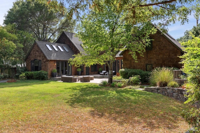 exterior space featuring a front lawn, a patio area, and an outdoor fire pit