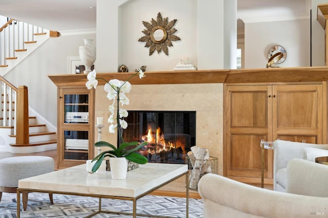 living room with crown molding and hardwood / wood-style flooring