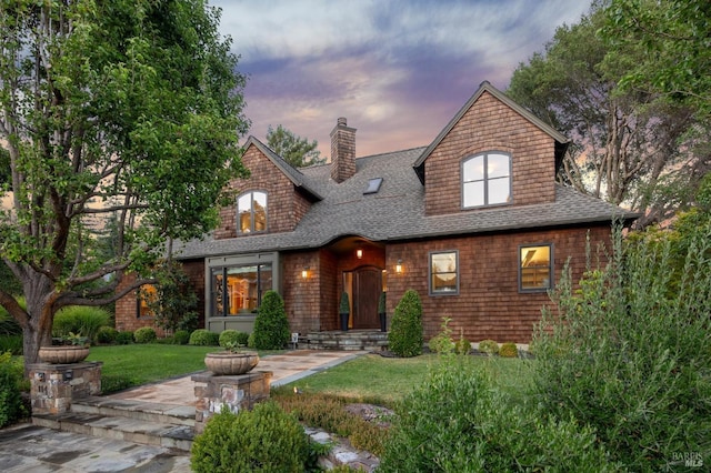 view of front of home featuring a patio and a yard