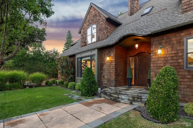 114 Van Tassel Ct, San Anselmo, CA 94960 - view of exterior entry with a chimney, a yard, and roof with shingles