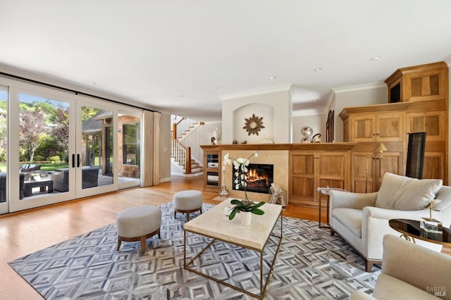 114 Van Tassel Ct, San Anselmo, CA 94960 - living area with stairway, a fireplace, light wood-style floors, ornamental molding, and french doors