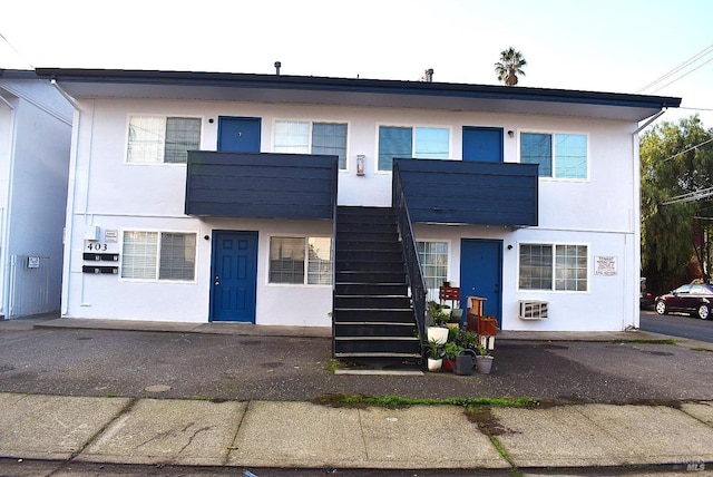 view of front of house featuring a balcony