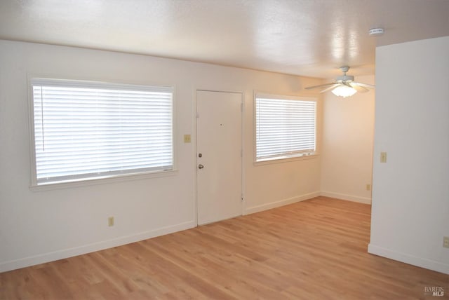 foyer with light hardwood / wood-style floors, ceiling fan, and plenty of natural light