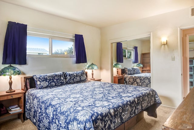 bedroom with carpet floors, a closet, and visible vents