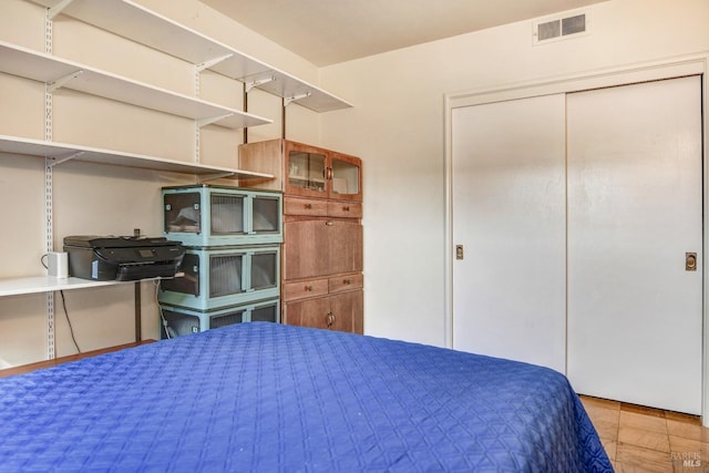 bedroom with a closet and visible vents
