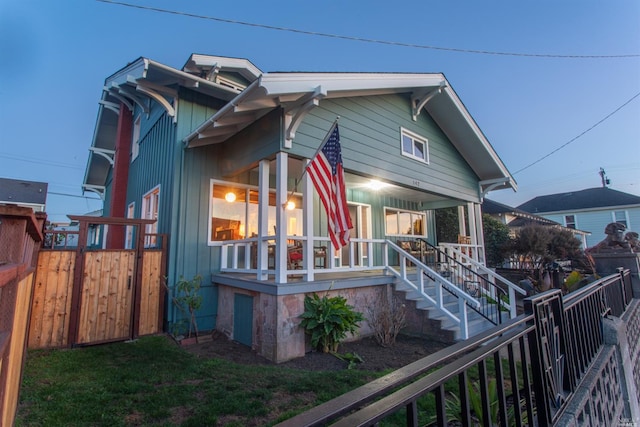 view of side of property with covered porch