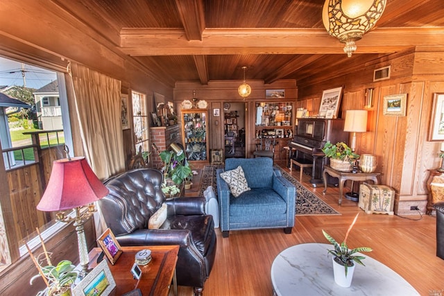 living room with wooden ceiling, wood walls, beamed ceiling, and hardwood / wood-style flooring