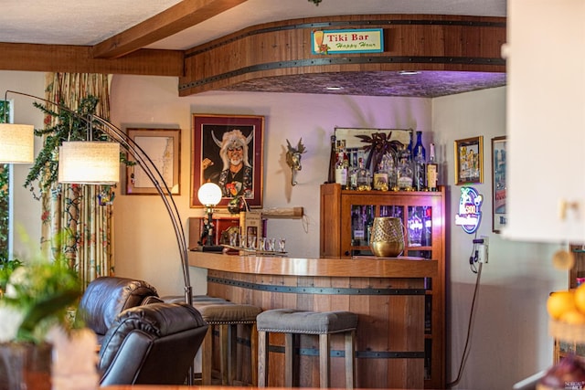 bar featuring beam ceiling