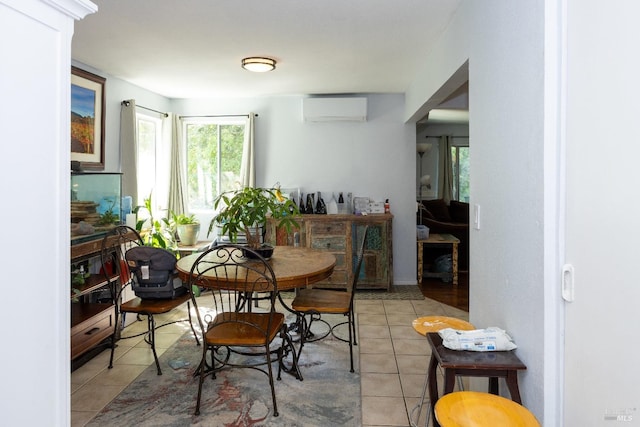 dining space with light tile patterned flooring and a wall mounted air conditioner