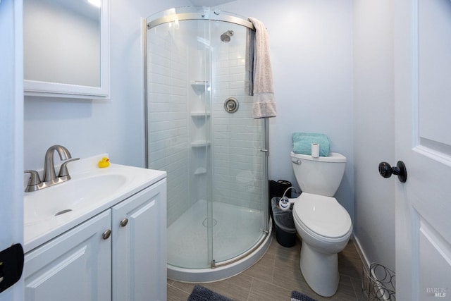 bathroom with walk in shower, vanity, and toilet