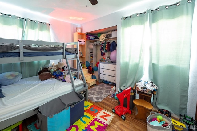 bedroom featuring hardwood / wood-style floors, ceiling fan, and a closet