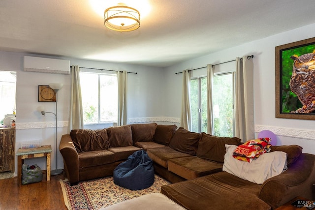 living room with dark wood-type flooring and a wall mounted air conditioner