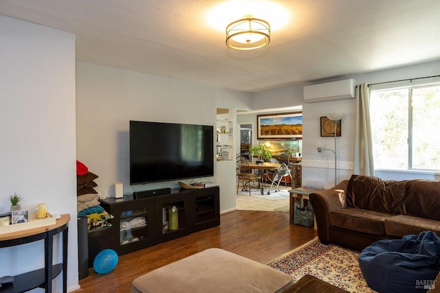 living room with a wall unit AC and hardwood / wood-style flooring