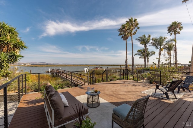 wooden terrace featuring a water view