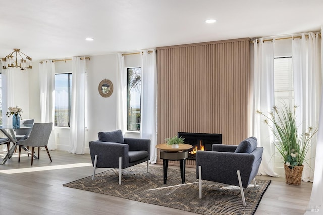 interior space with hardwood / wood-style flooring, a large fireplace, and a wealth of natural light