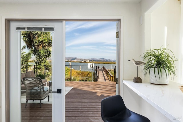 doorway featuring hardwood / wood-style floors and a water view