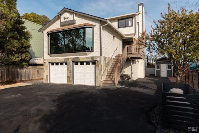 view of home's exterior with a storage unit and a garage