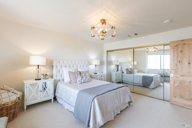 carpeted bedroom featuring an inviting chandelier and a closet