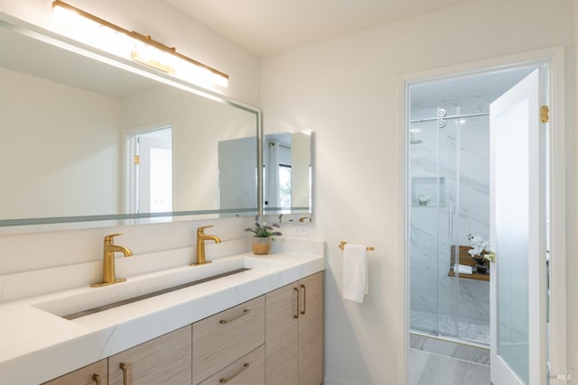 bathroom with walk in shower and vanity