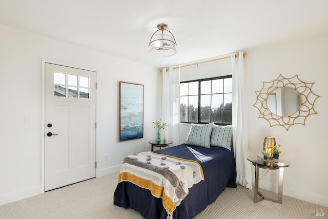 bedroom with carpet floors and a notable chandelier