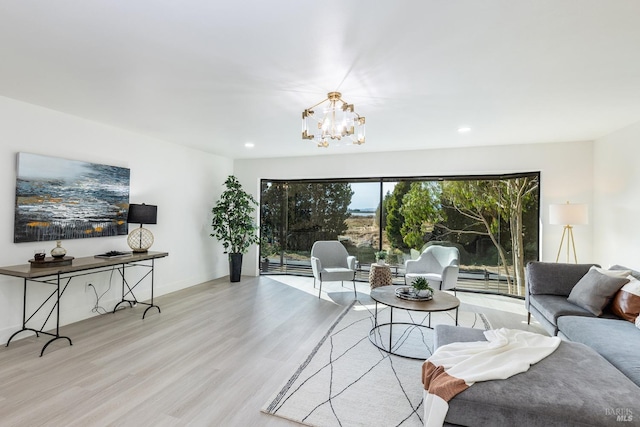 living room with an inviting chandelier and light wood-type flooring