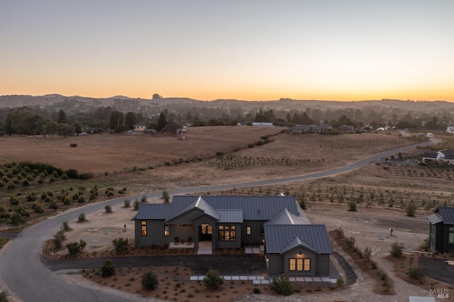 aerial view at dusk featuring a mountain view