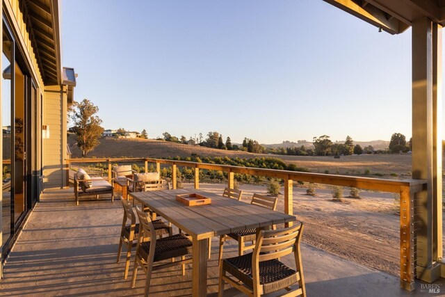 wooden deck with a rural view