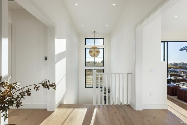 interior space with a notable chandelier and light hardwood / wood-style floors