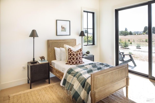 bedroom featuring light hardwood / wood-style flooring and access to exterior