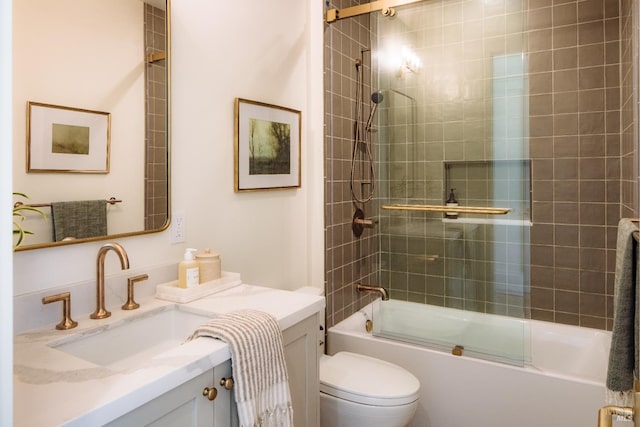 full bathroom with combined bath / shower with glass door, vanity, and toilet