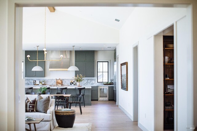 kitchen with pendant lighting, hardwood / wood-style flooring, a kitchen breakfast bar, and tasteful backsplash