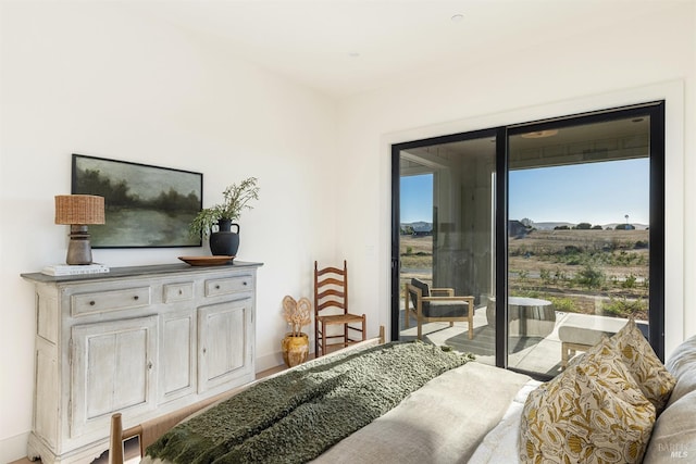 bedroom featuring hardwood / wood-style floors and access to outside