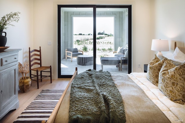 bedroom featuring access to outside and light hardwood / wood-style flooring