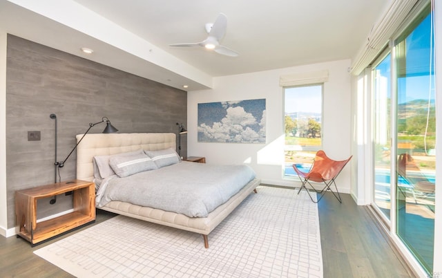 bedroom with access to outside, hardwood / wood-style floors, and ceiling fan