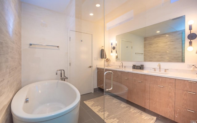 bathroom featuring tile walls, vanity, tile patterned floors, and a washtub