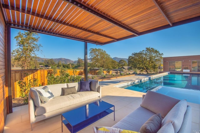 exterior space with a patio, outdoor lounge area, and a mountain view