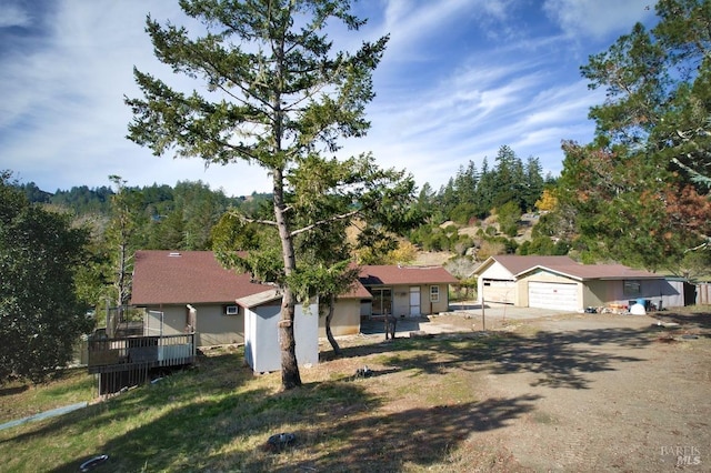 single story home featuring a garage and a deck