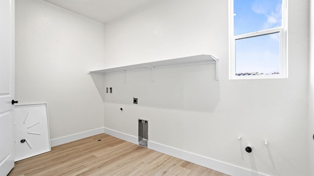 washroom featuring hookup for an electric dryer, hookup for a gas dryer, hookup for a washing machine, and light hardwood / wood-style flooring