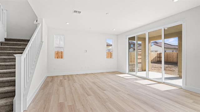 unfurnished living room with a wealth of natural light and light wood-type flooring