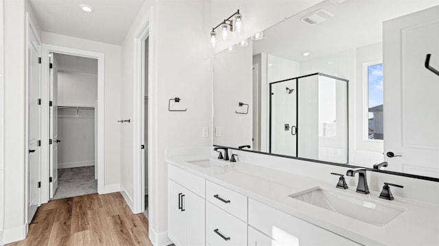 bathroom with vanity, hardwood / wood-style floors, and an enclosed shower