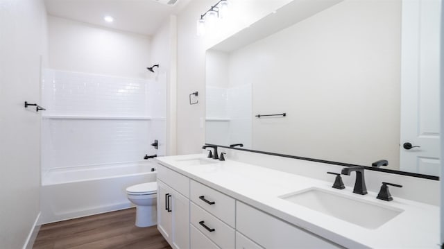 full bathroom with wood-type flooring,  shower combination, vanity, and toilet