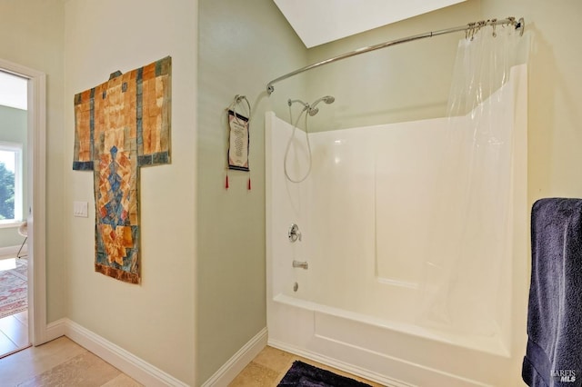 full bath featuring tub / shower combination and baseboards