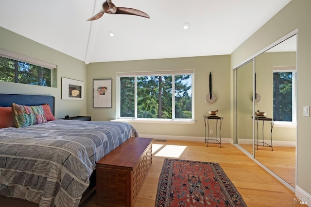 bedroom with ceiling fan, hardwood / wood-style flooring, a closet, and multiple windows