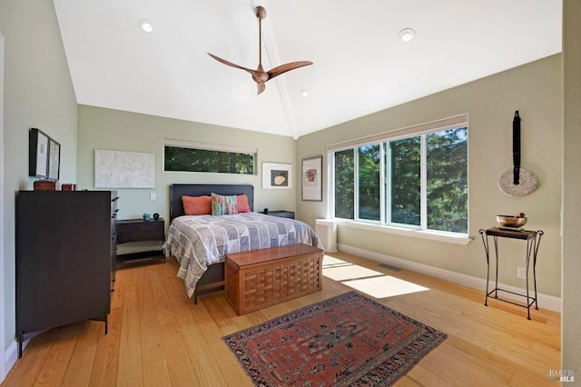 bedroom with visible vents, baseboards, light wood-style floors, lofted ceiling, and ceiling fan