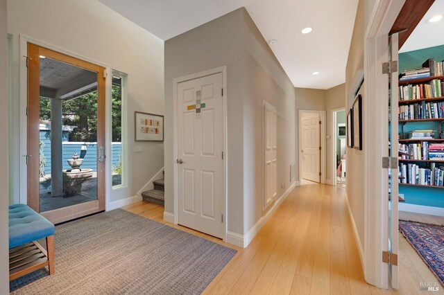 corridor with light hardwood / wood-style flooring