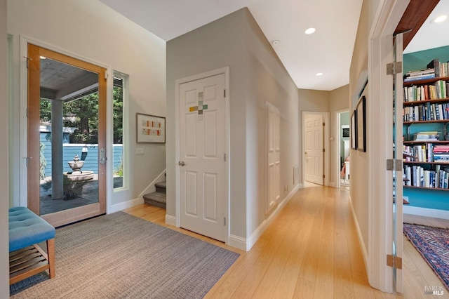 corridor with stairway, recessed lighting, baseboards, and light wood-type flooring