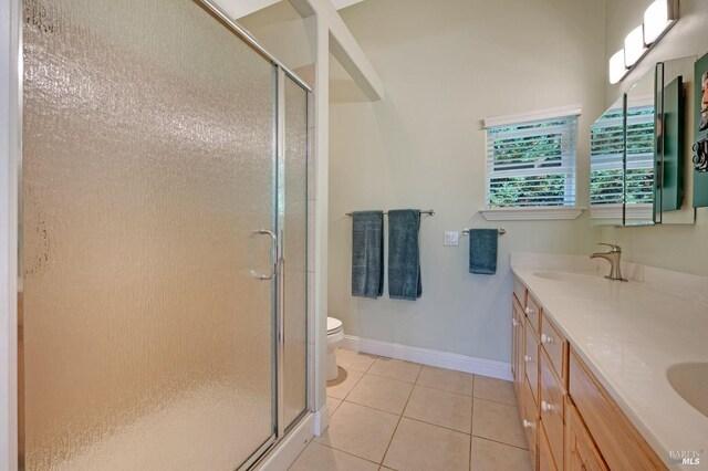 bathroom with vanity, toilet, and an enclosed shower