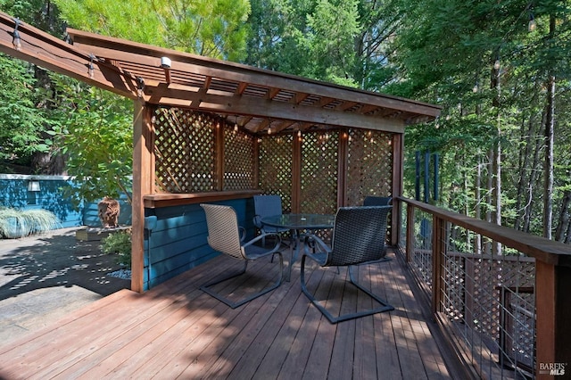 wooden deck featuring outdoor dining area and a pergola