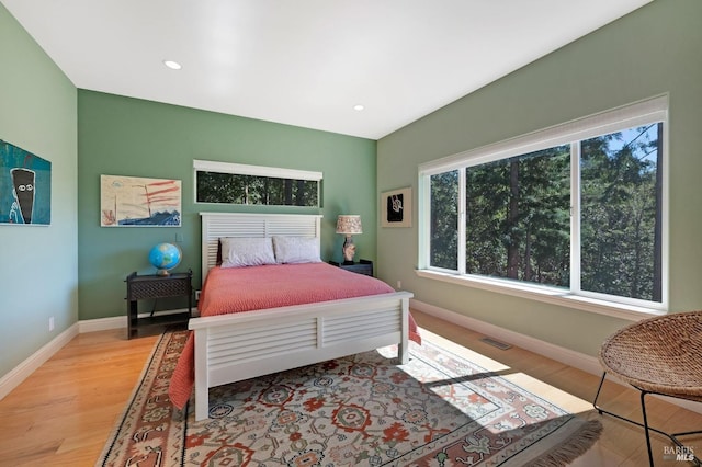 bedroom with visible vents, recessed lighting, baseboards, and wood finished floors