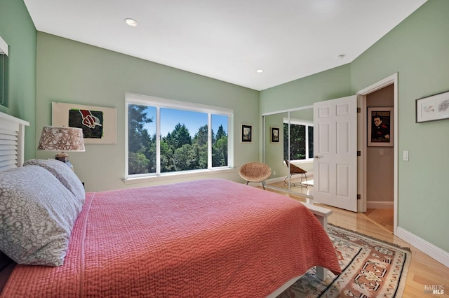 bedroom featuring light wood-type flooring and a closet